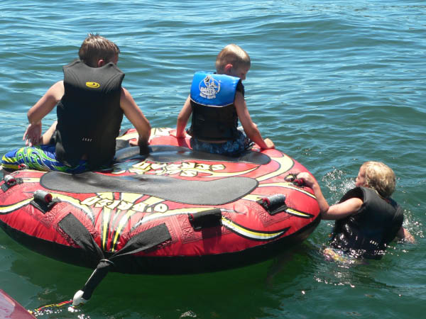 Katherine "tows" the tube, as Nicholas and Alex ride