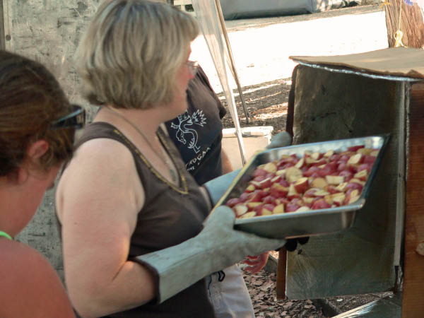 Mary gets ready to roast the potatoes.