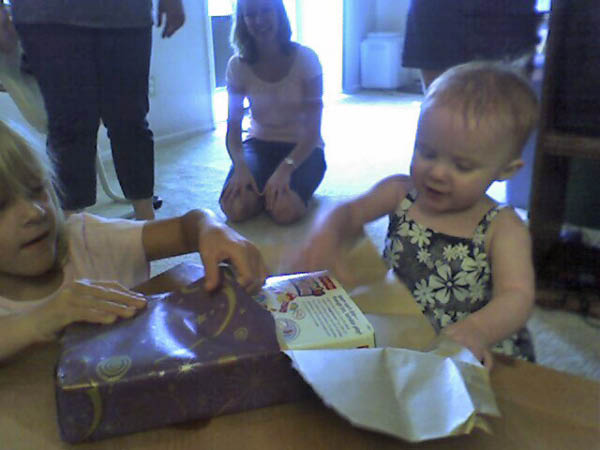 Katherine helps Kaylee open gifts